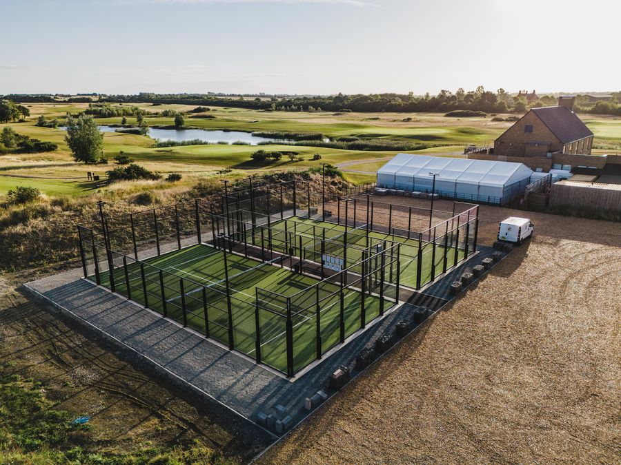 The padel courts and the clubhouse marquee in the morning, from the air