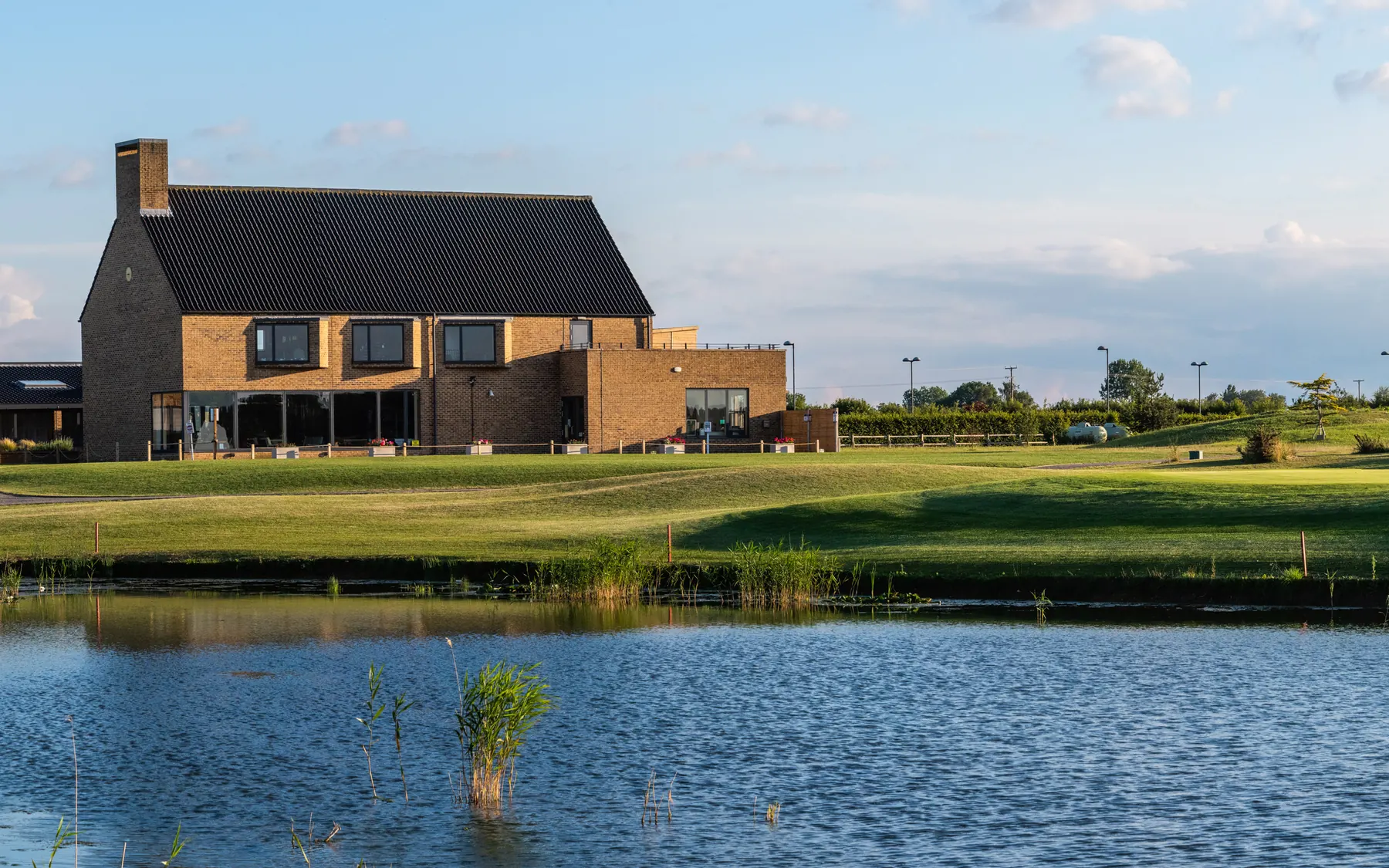 The clubhouse across the lake on a summer evening