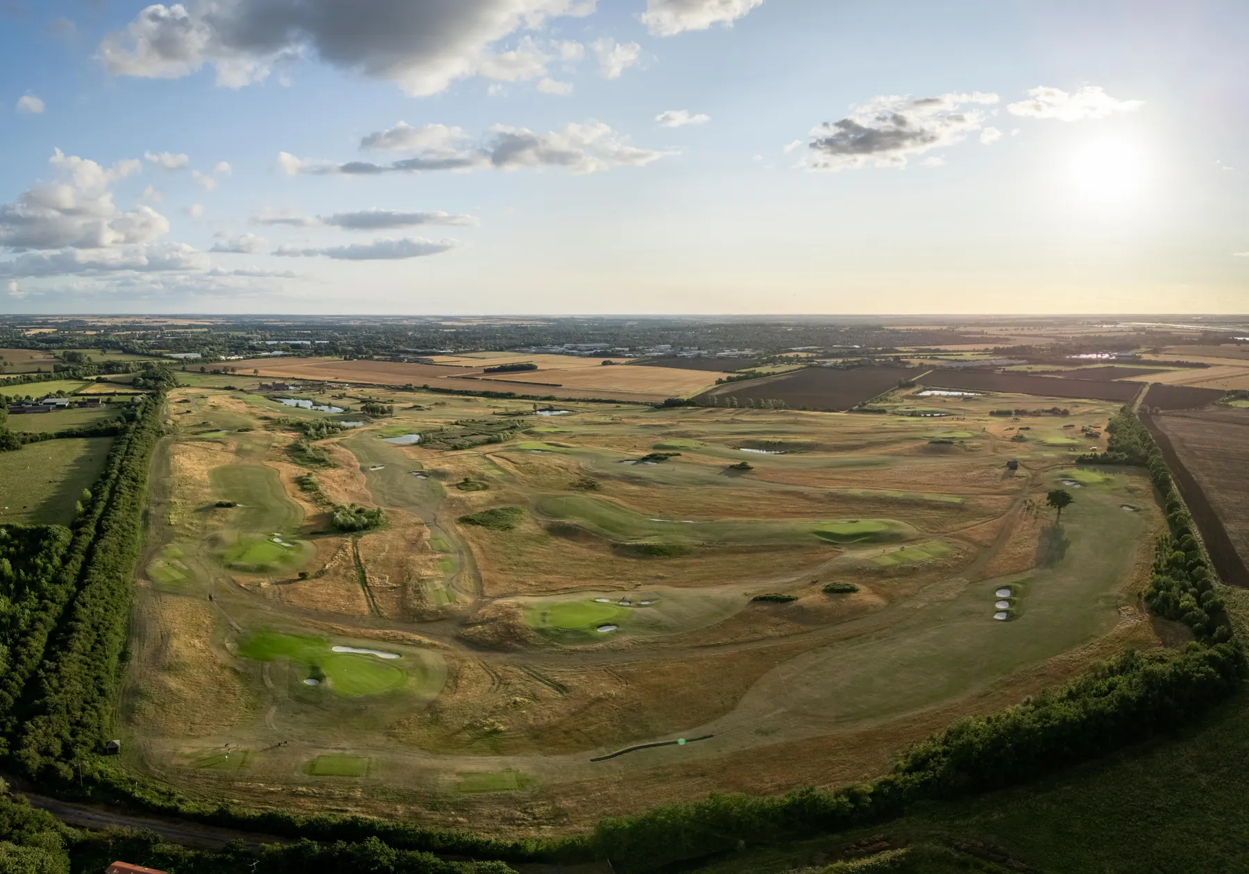The St Ives course from the air, fairways and lakes running out across Cambridgeshire
