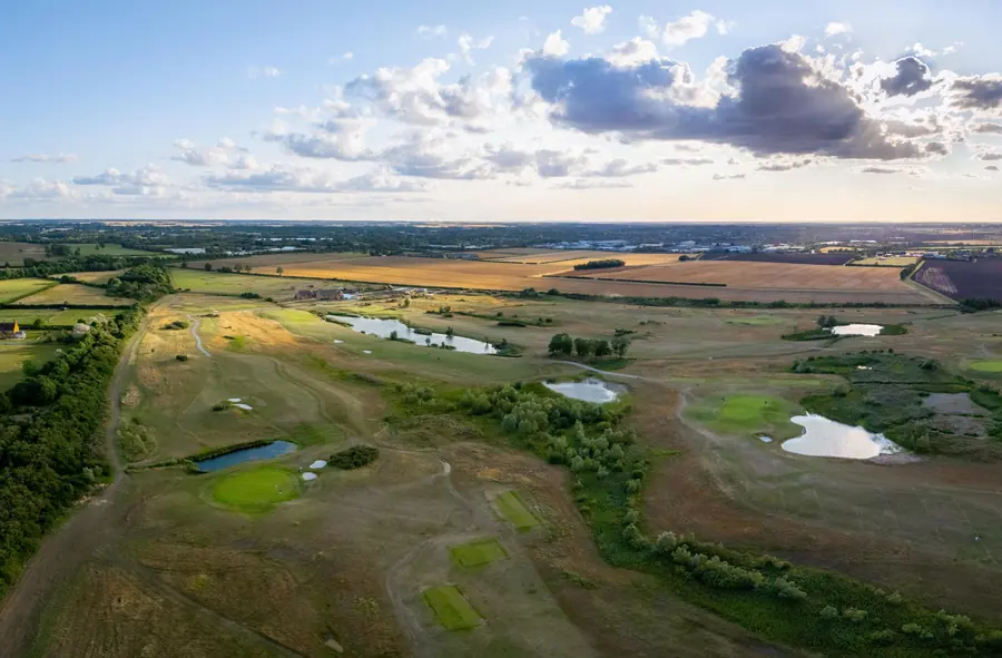 Holes threaded between lakes and rough, from high above