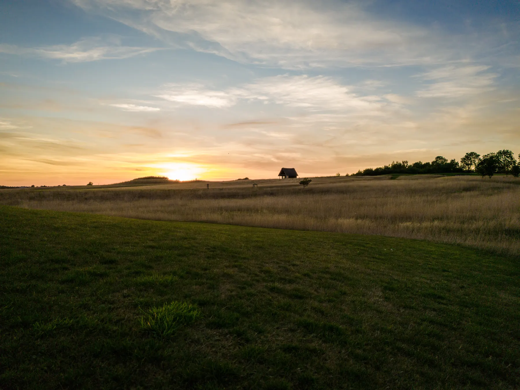 The sun setting low over the course